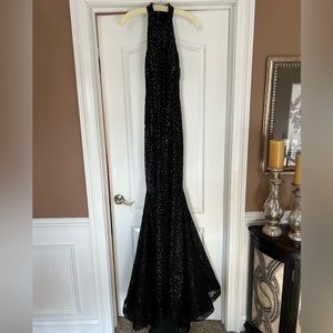 Jovani formal gown. Black with lace and sequin, sheer sides, fit and flare.